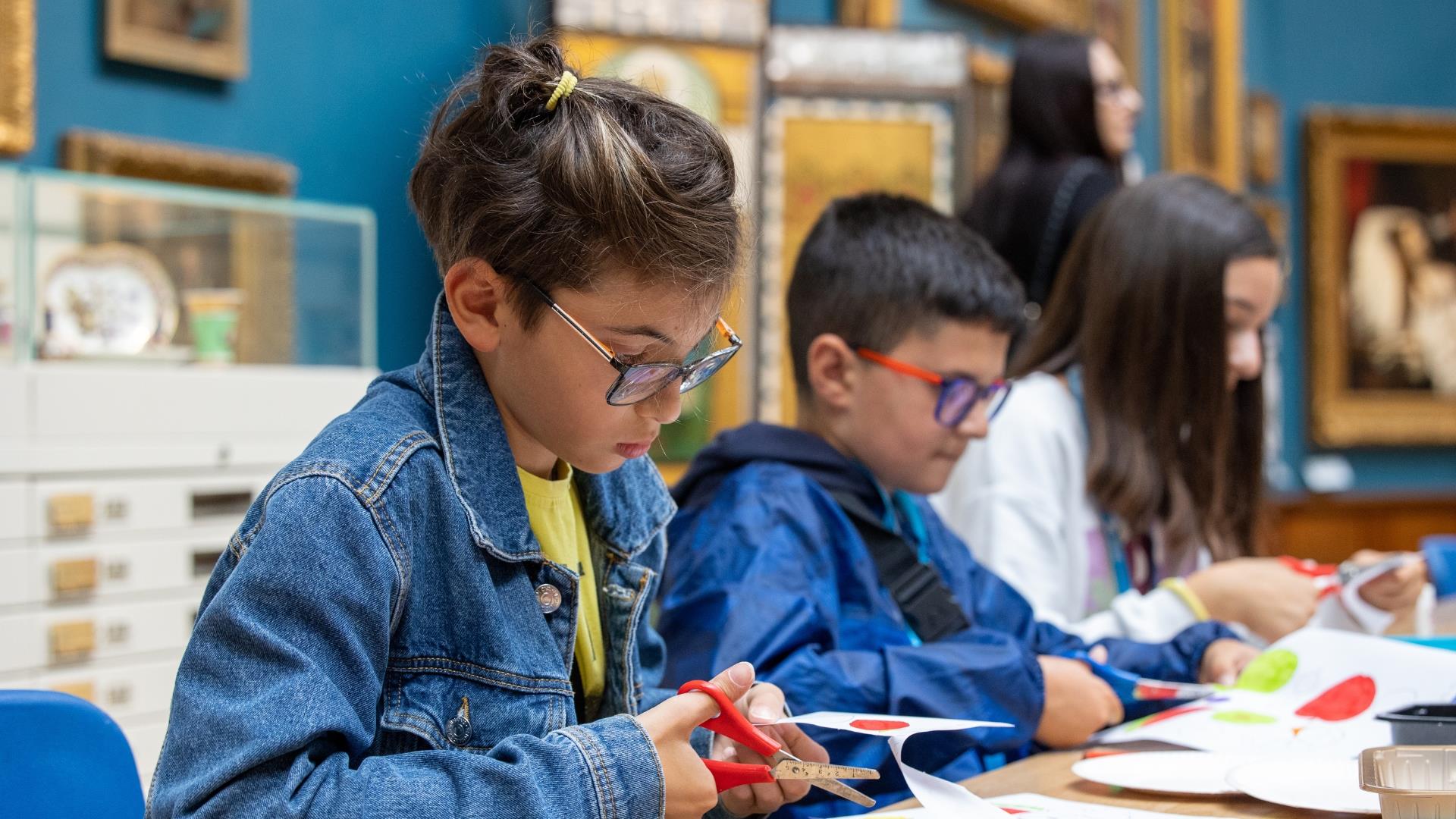 A group of children enjoying crafting activities at Victoria Art Gallery in Bath.