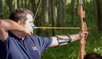 A man holding a bow and arrow 
