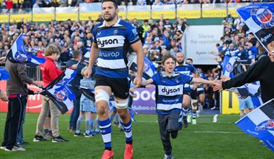 Bath Rugby players walking out of the tunnel onto the field 