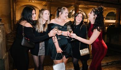 Party-goers cheers around the Roman Baths at Christmas