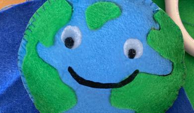 A felt Earth with googly eyes