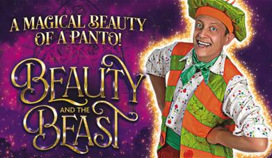A man in a pantomime gives a friendly pose. There's a castle in the background.  