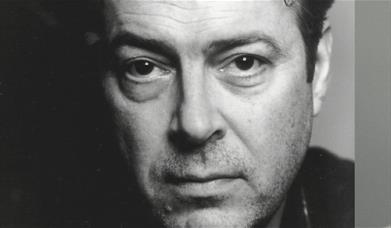 A black and white image of  actor Roger Allam. 