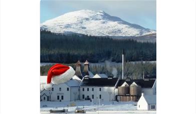 a snow scene of dalwhinnie distillery with a santa hat on it