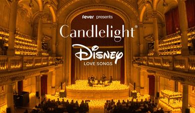 A string quartet plays surrounded by candles