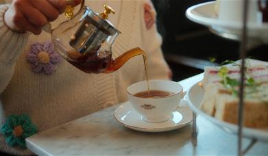 Person pouring tea 