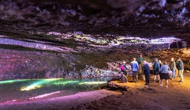 Visitors walking through one of the show caves at Wookey Hole Caves
