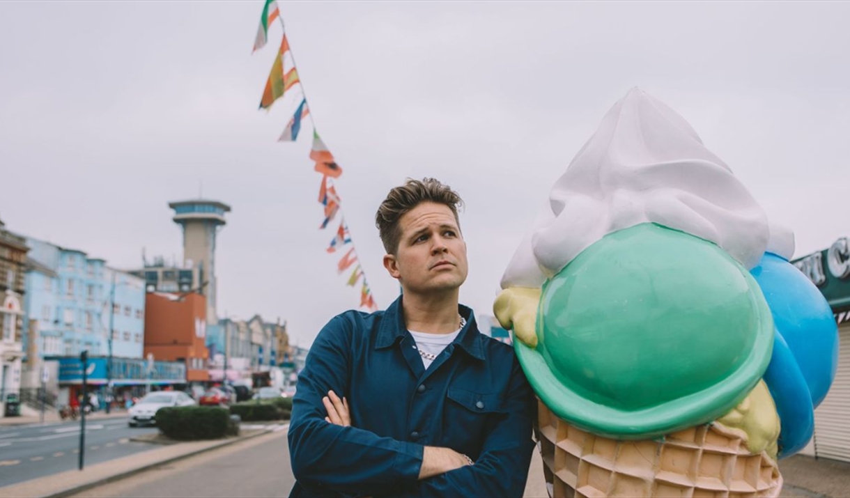 Luke Wright stood next to a statue of an ice cream