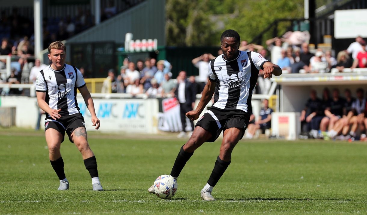 Bath City football club player kicking the ball