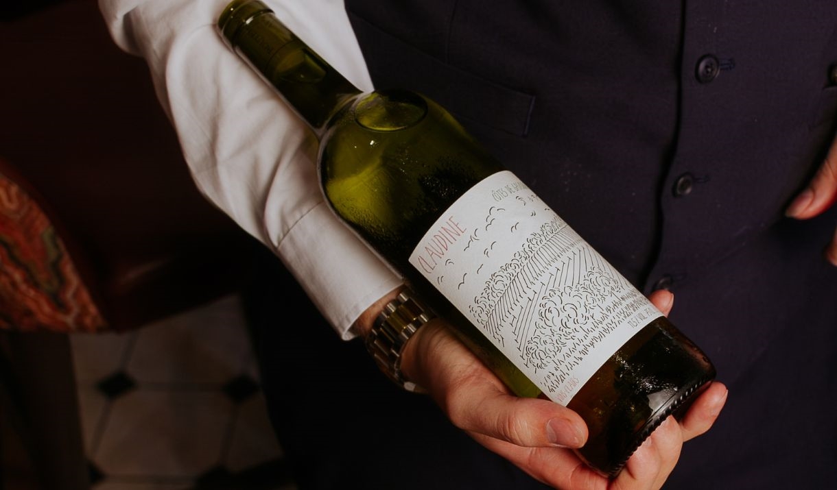 A bottle of red being presented