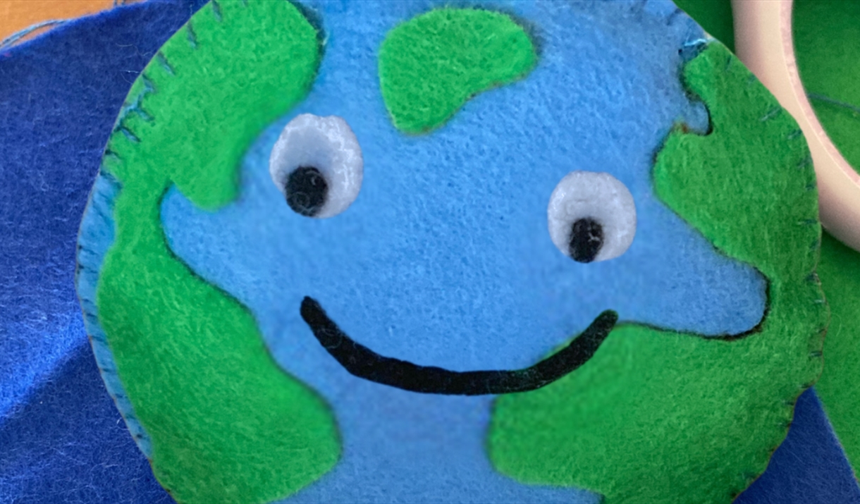 A felt Earth with googly eyes