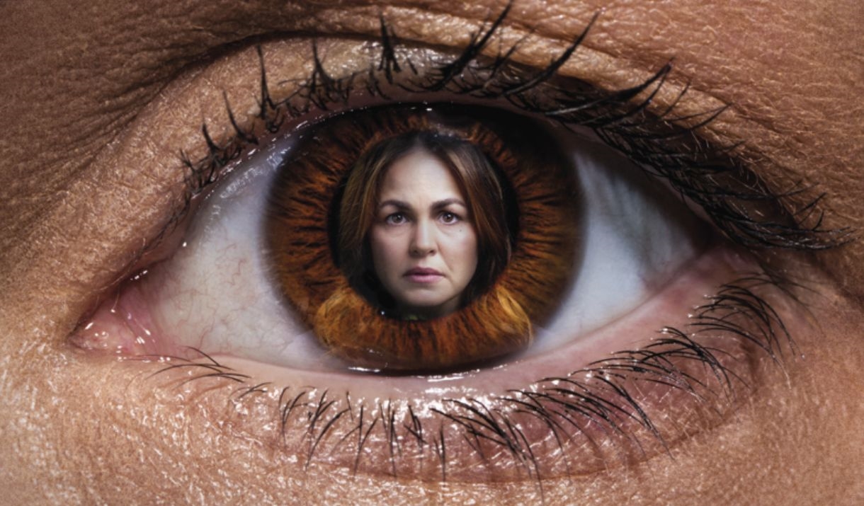 A large eye is displayed with a concerned woman's face.