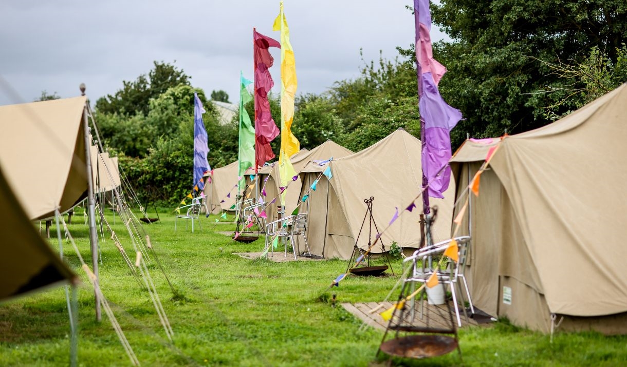 Rows of large tents, with brightly-coloured flags in front of each