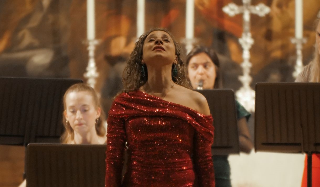 Opera singer surrounded by orchestra