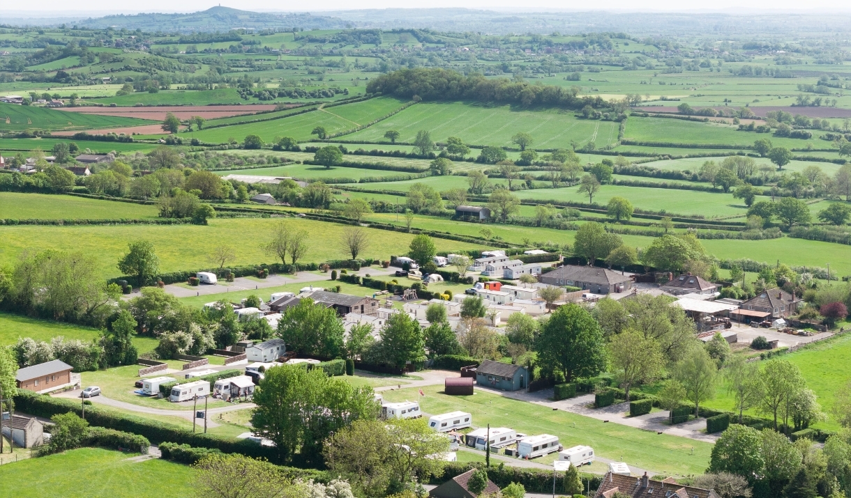 An aerial view of Bucklegrove Holiday Park, with Glastonbury Tor visible in the background