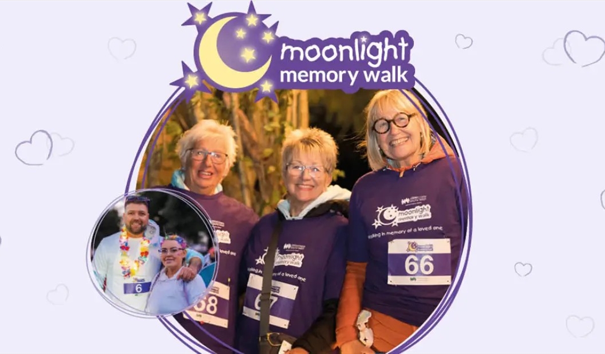 A group of friends taking part in Moonlight Memory Walk, surorunded by sparkling fairy lights