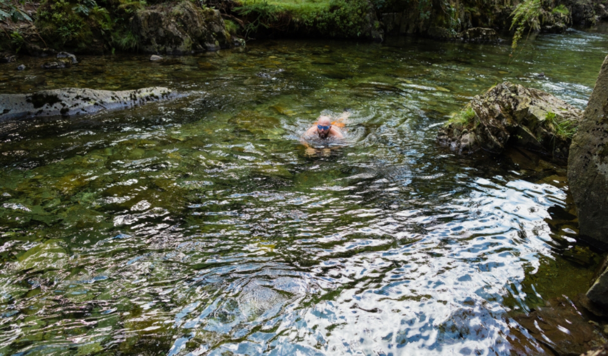 man swimming in river