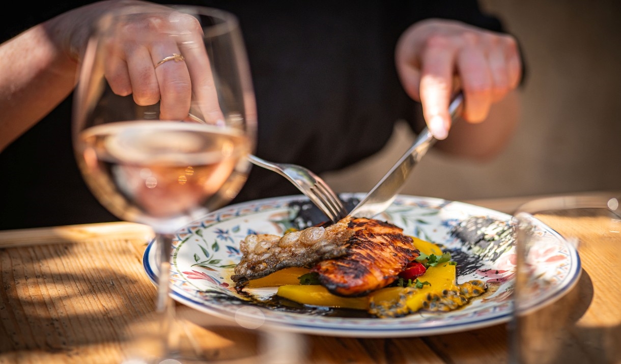A person eating one of the dishes available at Corkage in Bath.