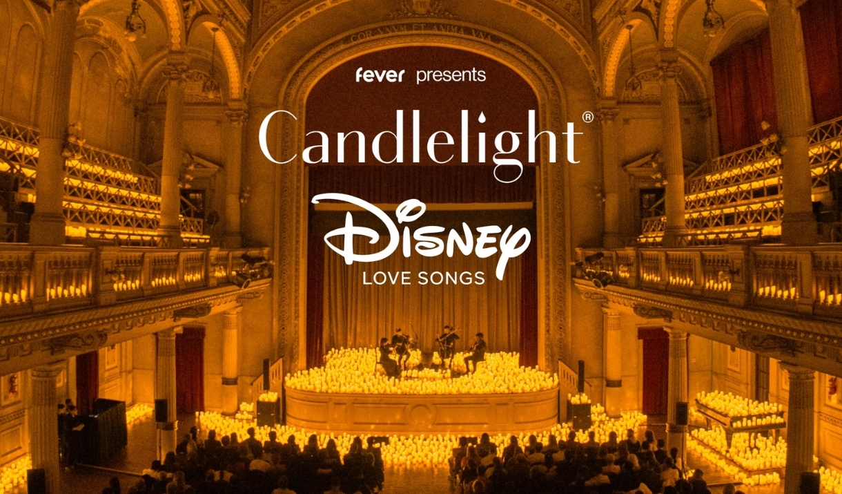 A string quartet plays surrounded by candles