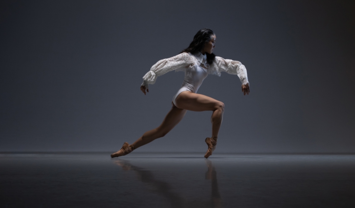 A ballerina with contemporary-style clothing and hair poses.