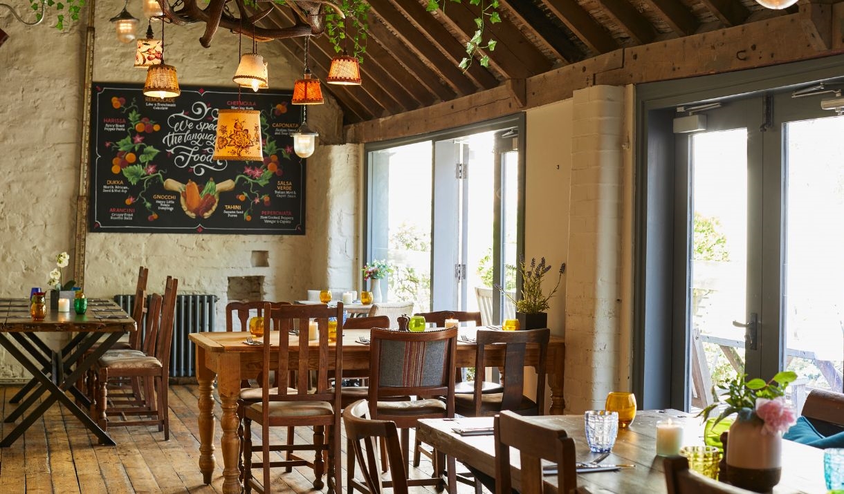 A large open pub with wooden tables and chairs