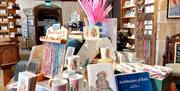 Bookmarks, pens, mugs, and books