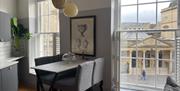 A modern grey dining room overlooking the Roman Baths.