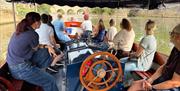 A group sat on a boat cruising on the River Avon