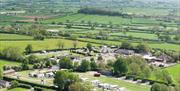 An aerial view of Bucklegrove Holiday Park, with Glastonbury Tor visible in the background