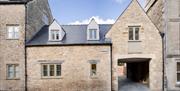The exterior of The Gatehouse, a large brick building with a built-in archway leading to the back of the property.
