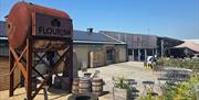 Outdoor barns with a rusty Flourish branded water tank outside