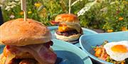 Three blue plates with brunch burgers on them