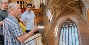 Tour guide presenting in a church or abbey in the Cotswolds