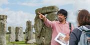 Jules presenting to his tour group in front of Stonehenge