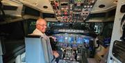 A man sat inside a jet flight simulator