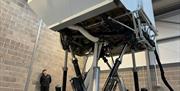 The exterior of a jet flight simulator raised into the air