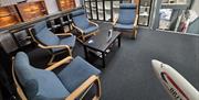 The waiting lounge at JetEx Simulation, with several chairs around a coffee table and a model British Airways jet