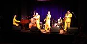 A group of performers on stage at the Chapel Arts Centre in Bath