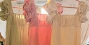 Three regency-inspired dressed hung up.