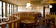 Dining area at Root Bath with a curved wooden divider