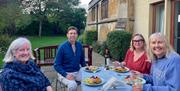 A group of four enjoying lunch outside