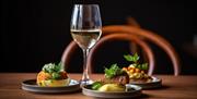 Various dinner options paired with a glass of white wine