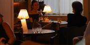 Two people talking at a table in the Bar at No.15 by GuestHouse, Bath