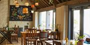 A large open pub with wooden tables and chairs