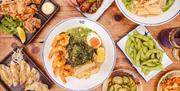 An overhead shot of Japanese ramen and side dishes.