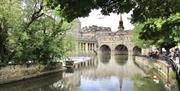 Down by the banks of the River Avon looking at the Pulteney Bridge