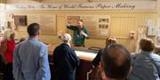 One of the guides at Wookey Hole demonstrating how paper was made on the site to visitors