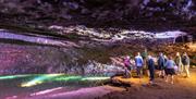 Visitors walking through one of the show caves at Wookey Hole Caves