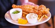 A plate of fish and chips in the restaurant at Wookey Hole Hotel